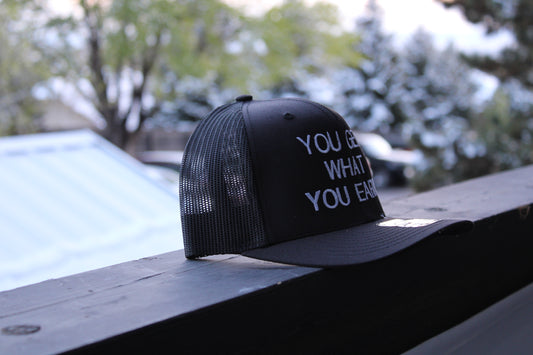 YOU GET WHAT YOU EARN - Black trucker Hat