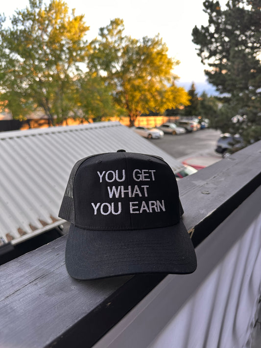 YOU GET WHAT YOU EARN - Black trucker Hat