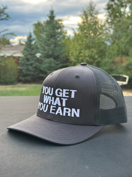 YOU GET WHAT YOU EARN - Black trucker Hat