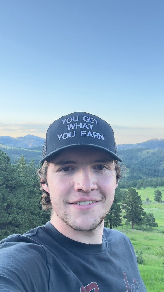 YOU GET WHAT YOU EARN - Black trucker Hat