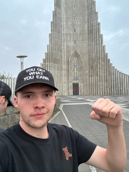 YOU GET WHAT YOU EARN - Black trucker Hat
