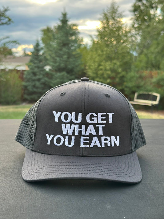 YOU GET WHAT YOU EARN - Black trucker Hat