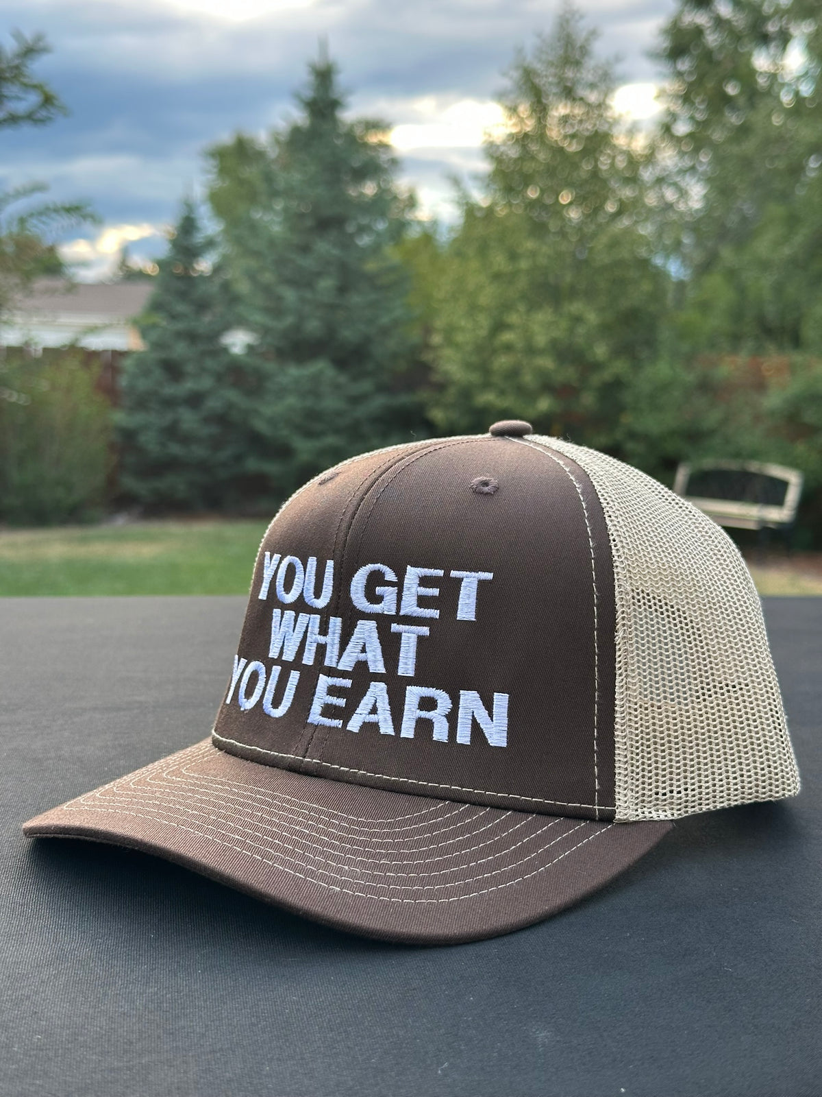 YOU GET WHAT YOU EARN - Black trucker Hat