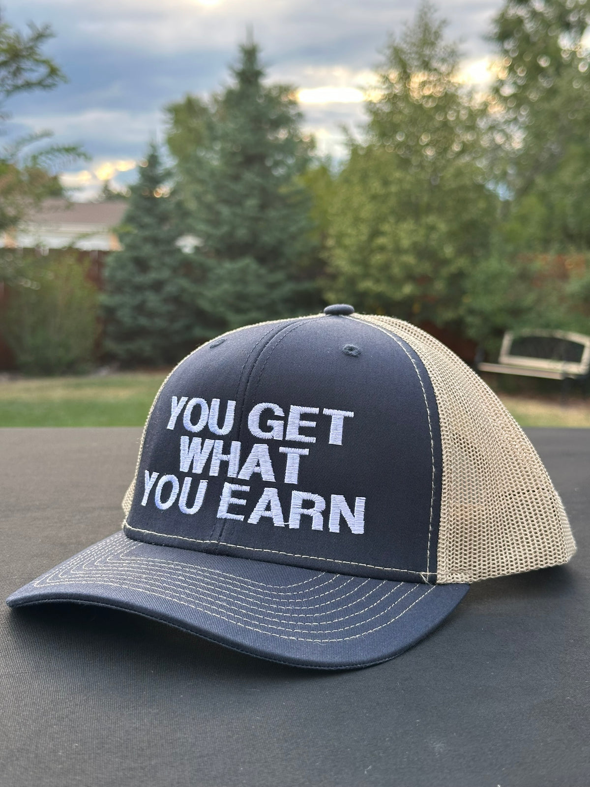 YOU GET WHAT YOU EARN - Black trucker Hat