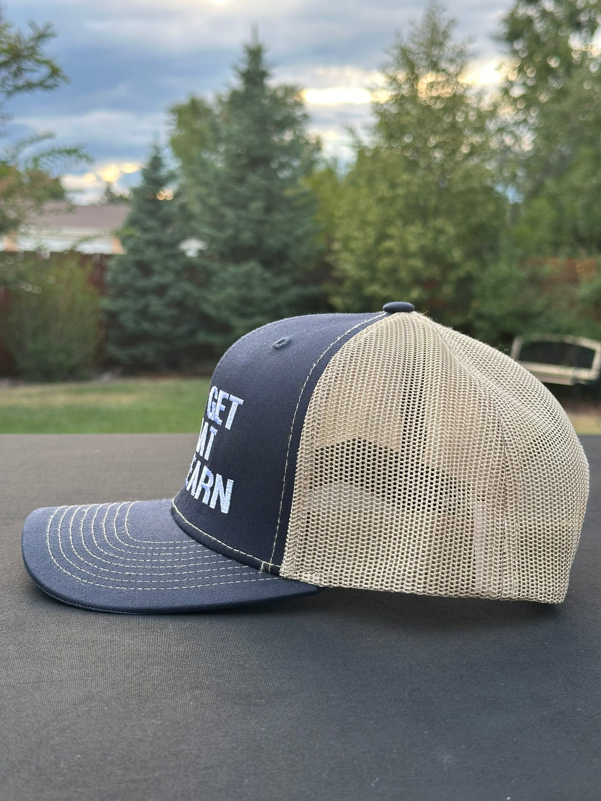 YOU GET WHAT YOU EARN - Black trucker Hat